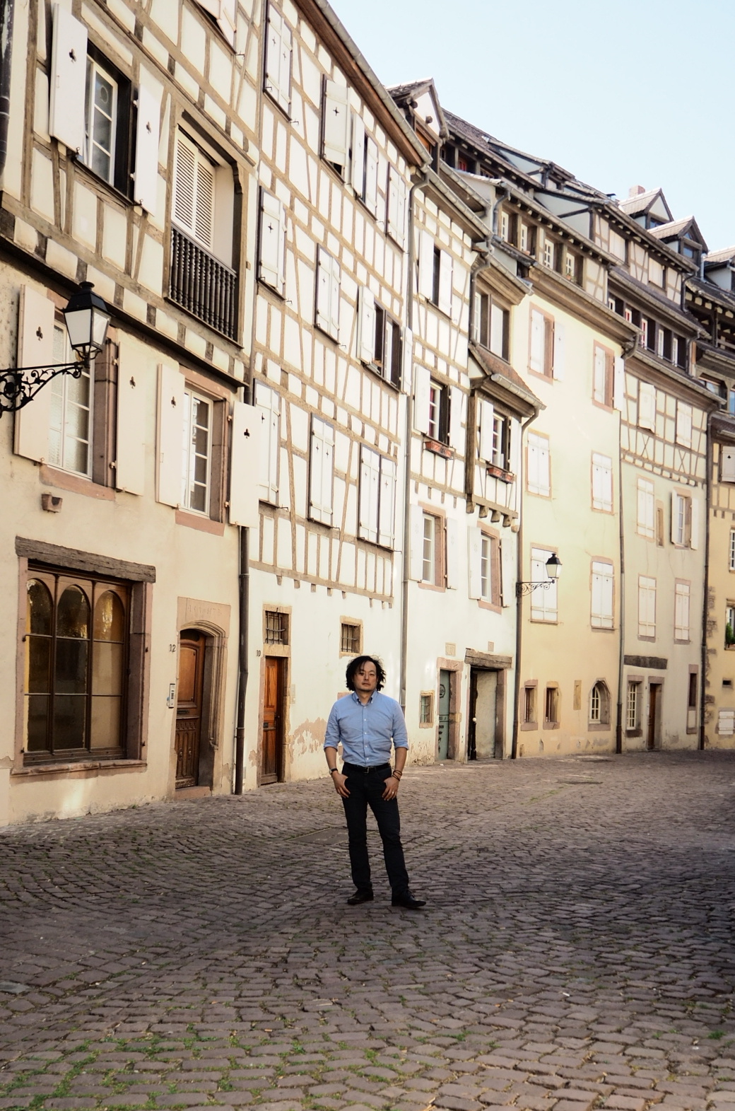 Yoshi standing in a deserted sidestreet in Colmar